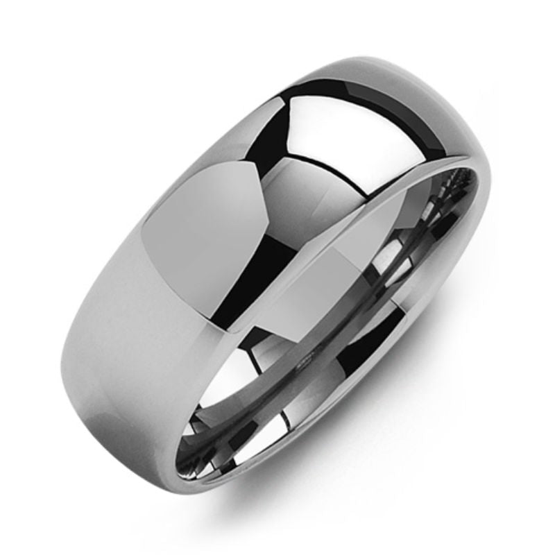 A close-up image of the Madani Classic Wide Polished Tungsten Wedding Band showcases its shiny, polished surface. The smooth, reflective finish displays facets of light, highlighting the jewelry's rounded edges and sleek 8mm wide design.