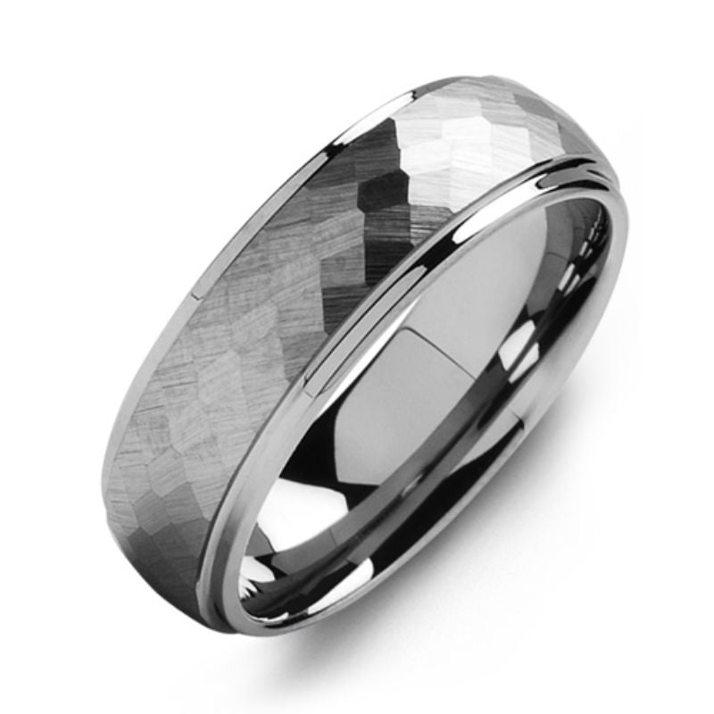 A close-up of the Madani Matte Tungsten Wedding Band showcases its reflective surface, hammered design, and polished edges, set against a white background.