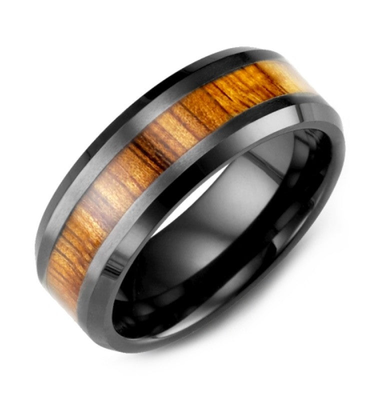 The Madani Beveled Black Ceramic with Wood Inlay Wedding Band features a polished design with a central inlay of brown wood grain, adding a natural touch. Elegantly presented against a plain white background, this piece embodies the refined craftsmanship of the Madani brand.