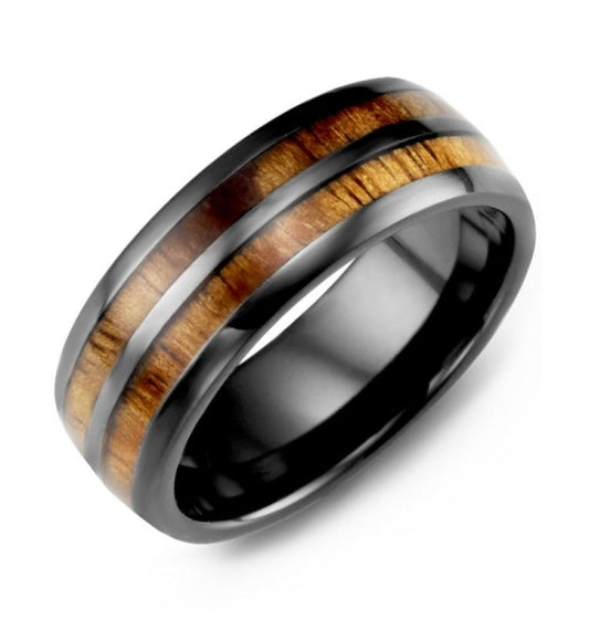 The Madani Dome Black Ceramic and Koa Wood Wedding Band is a stylish piece featuring two polished Koa wood inlay bands that boast rich brown tones. Its smooth finish and the contrasting materials offer an elegant, modern design inspired by the timeless allure of a barrel style.