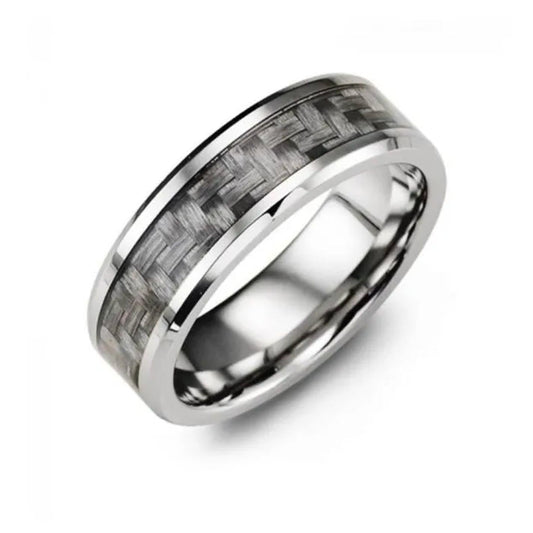 The Madani Beveled Cobalt And Carbon Fiber Wedding Band exudes a masculine accessory appeal with its textured pattern resembling woven carbon fiber inlay around the center. The polished and reflective finish beautifully contrasts against a white background.