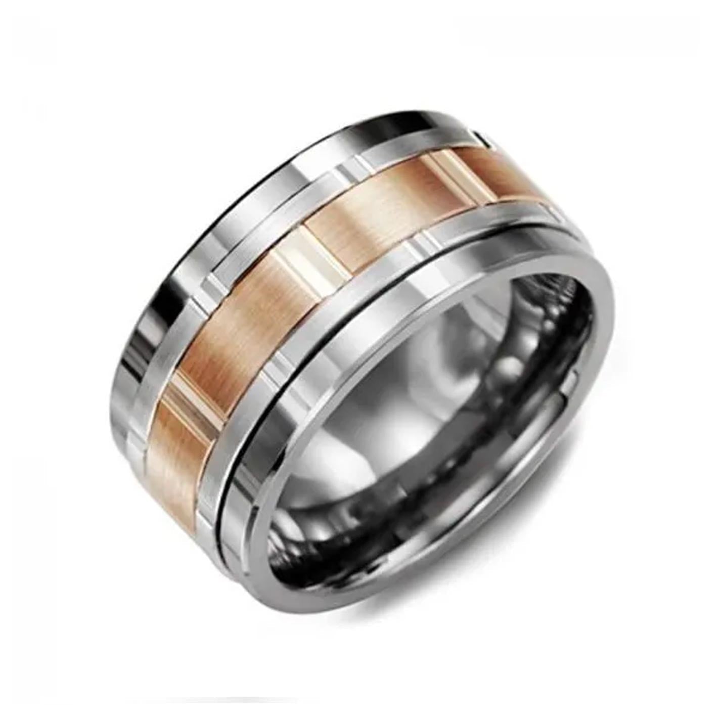 A close-up image of the Madani Tungsten and 10K Rose Gold Wedding Band showcases its contemporary style with a sleek design. The band, crafted from durable Tungsten, features a striking silver metal body highlighted by a brushed rose gold-colored stripe down the center. Its polished edges complete the modern aesthetic offered by Madani.