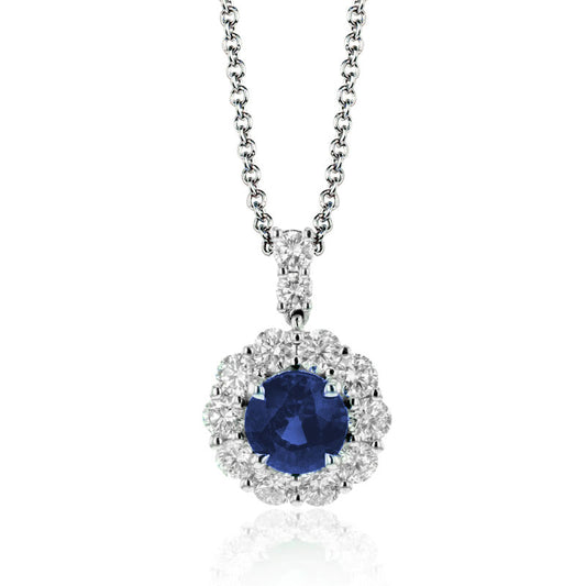 The Simon G. 18K White Gold Sapphire with Diamond Necklace Pendant features a deep blue sapphire set in a floral pattern of shimmering diamonds. The simple and elegant chain perfectly complements the intricate design of the white gold pendant.