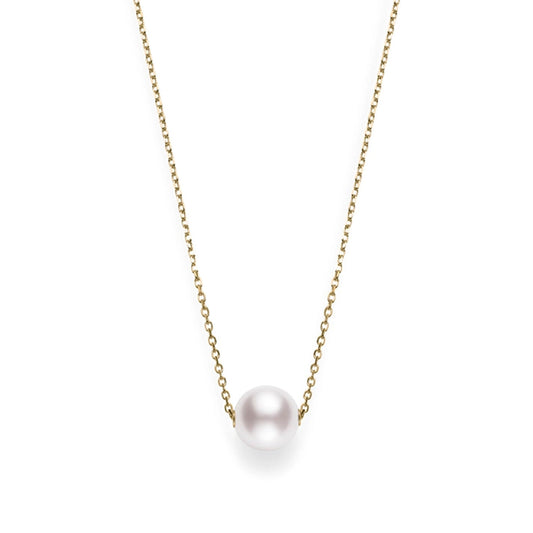 The Mikimoto 18K Yellow Gold Akoya Cultured Pearl Necklace Pendant showcases an elegant arrangement, with a delicate gold chain highlighting a beautifully centered Akoya cultured pearl. The necklace is set against a simple white background to emphasize its sophistication.