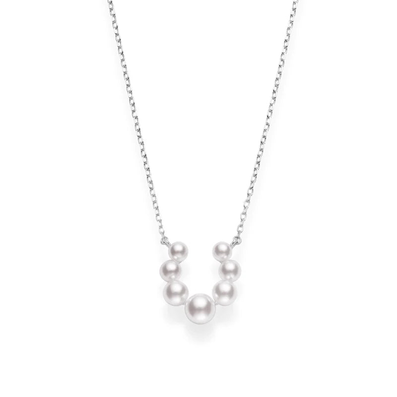 The Mikimoto Bubbles 18K White Gold Pearl Necklace Pendant by Mikimoto features seven lustrous Akoya cultured pearls of varying sizes arranged in a graceful curve at the center of a white gold chain, creating an elegant pendant that exudes timeless sophistication.