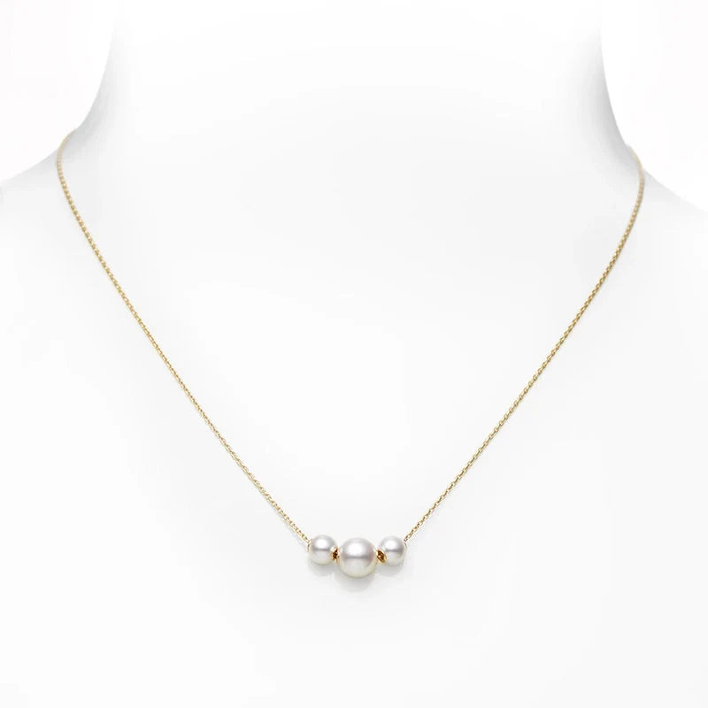 The Mikimoto Pearls In Motion 18K Yellow Gold Pearl Necklace Pendant by Mikimoto showcases three evenly spaced Akoya cultured pearls, elegantly set against a white background.