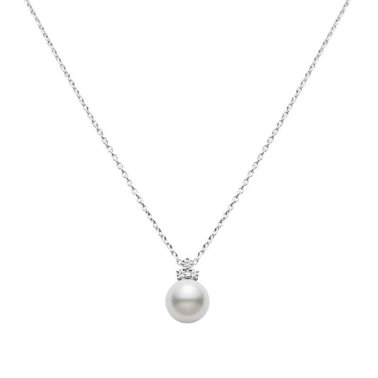 A refined 18K white gold necklace by Mikimoto features a single South Sea Pearl pendant, elegantly adorned with small sparkling diamonds, all set against a simple white background.