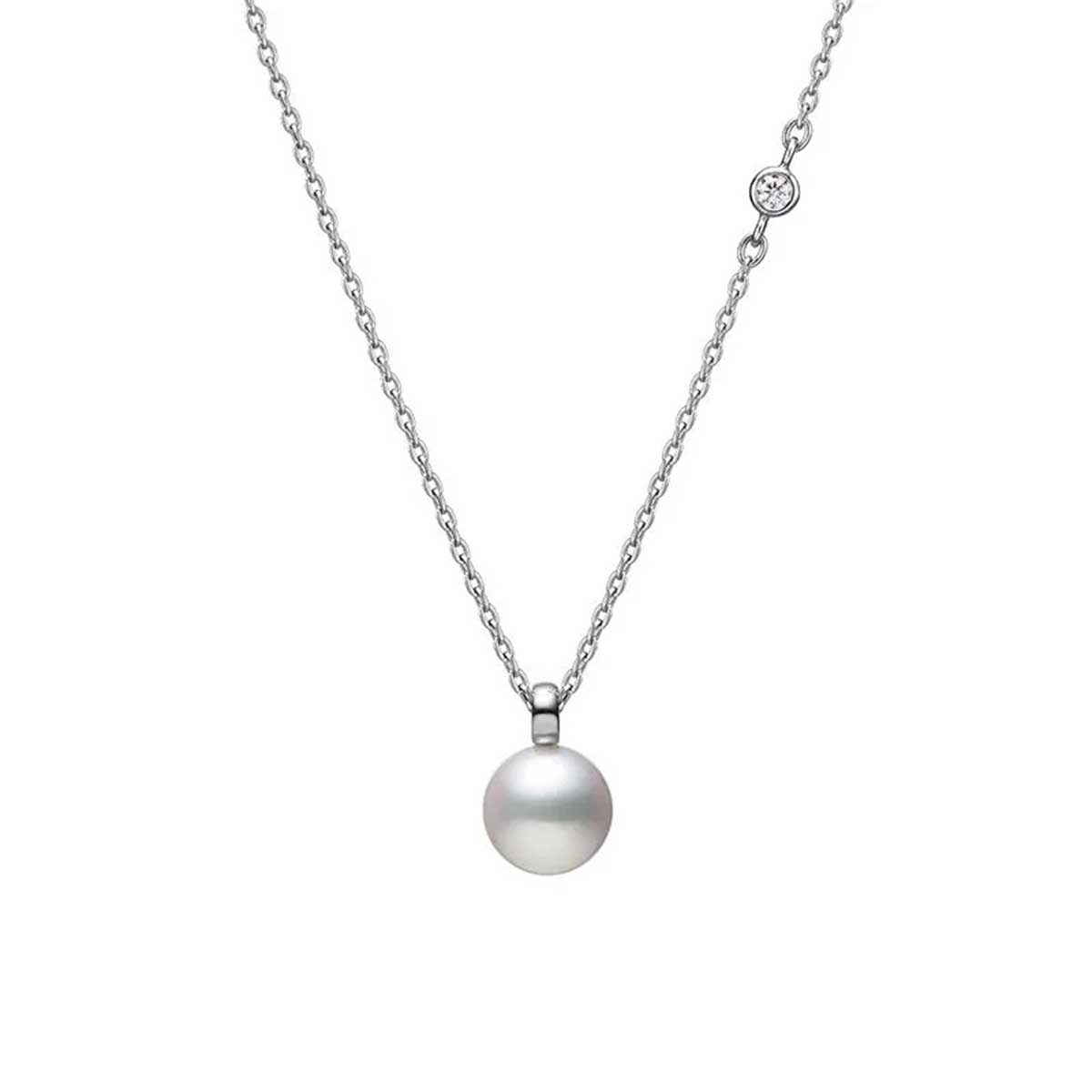 The Mikimoto Classic Collection necklace is a delicate piece crafted from 18K white gold, featuring a round Akoya cultured pearl pendant and accented with a small diamond on the chain.