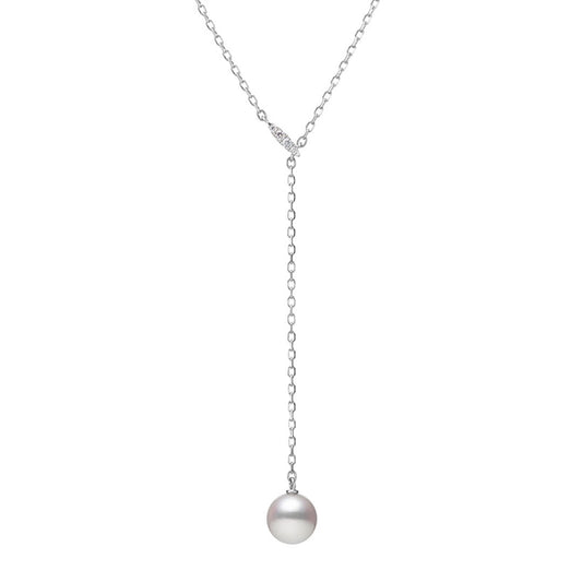 The Mikimoto 18K White Gold Akoya Cultured Pearl with Diamond Lariat Necklace Pendant features a single round Akoya pearl at the end of its delicate chain, representing the essence of minimalist luxury jewelry.