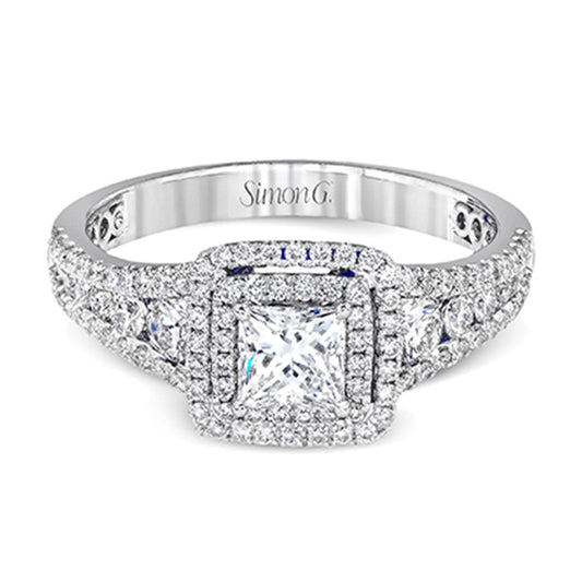 Introducing the Simon G. 18K White Gold Princess Cut Diamond Ring, a stunning engagement piece with a sparkling princess-cut center stone encircled by a halo of smaller diamonds. The band is adorned with diamonds and engraved with the brand name "Simon G.