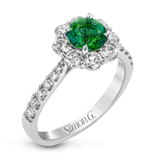 Introducing the Simon G. 18K White Gold Emerald with Diamond Fashion Ring, featuring a captivating green emerald center surrounded by smaller, shimmering white diamonds. The exquisite band is adorned with additional tiny diamonds, exuding a luxurious sparkle that embodies the elegance of white gold.