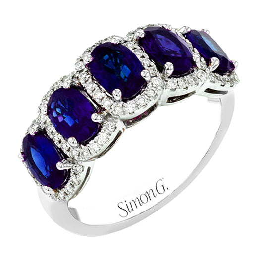 Introducing the Simon G. 18K White Gold Sapphire with Diamond Ring, a stunning piece by Simon G that features five oval-cut deep blue sapphires, each elegantly encircled by small sparkling diamonds. Crafted with precision in 18K white gold, this exquisite ring radiates elegance and sophistication.