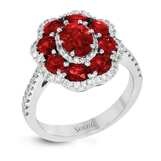 The Simon G. 18K White Gold Ruby with Diamond Ring by Simon G showcases a floral-inspired design featuring a cluster of round red rubies encircled by small, sparkling round white diamonds along the band.