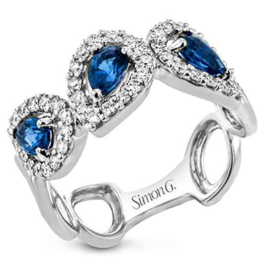 A stunning 18K white gold Simon G. ring featuring three pear-shaped sapphires, each encircled by small clear diamonds, with "Simon G." engraved on the inside of the band.