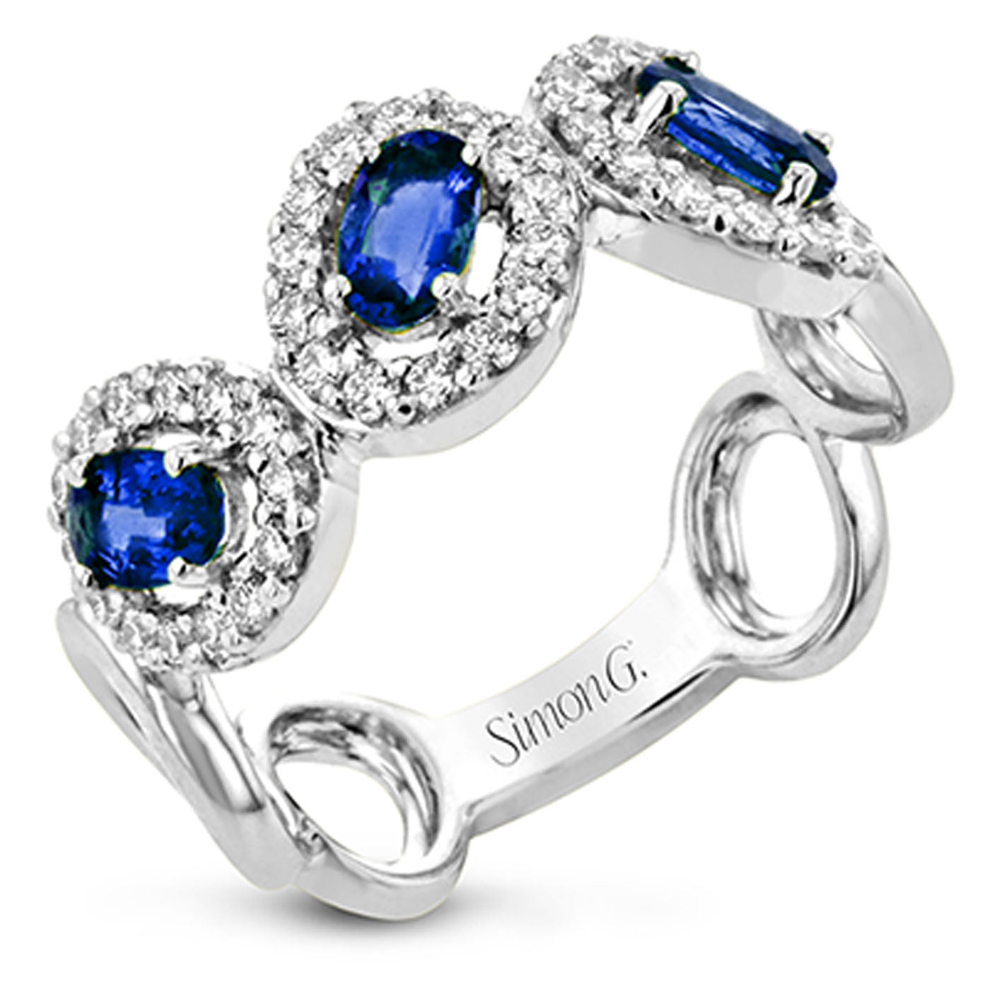 Introducing the Simon G. 18K White Gold Sapphires with Diamond Ring, a captivating masterpiece featuring three oval sapphires gracefully encircled by round diamonds. The exquisite blue gemstones harmoniously enhance the elegant setting, crafting a timeless piece of jewelry that exudes charm and sophistication.