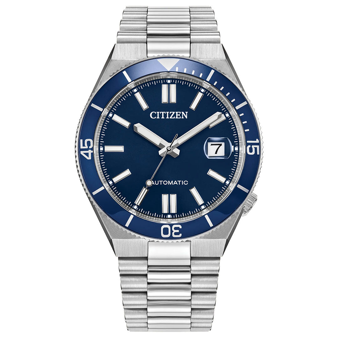 The CITIZEN Tsuyosa Shore Automatic 40mm Watch features a stainless steel case and bracelet, blue dial with white hour markers, silver hands, date at 3 o’clock, automatic Calibre 8210, and bezel minute markers at 15, 30, and 45.