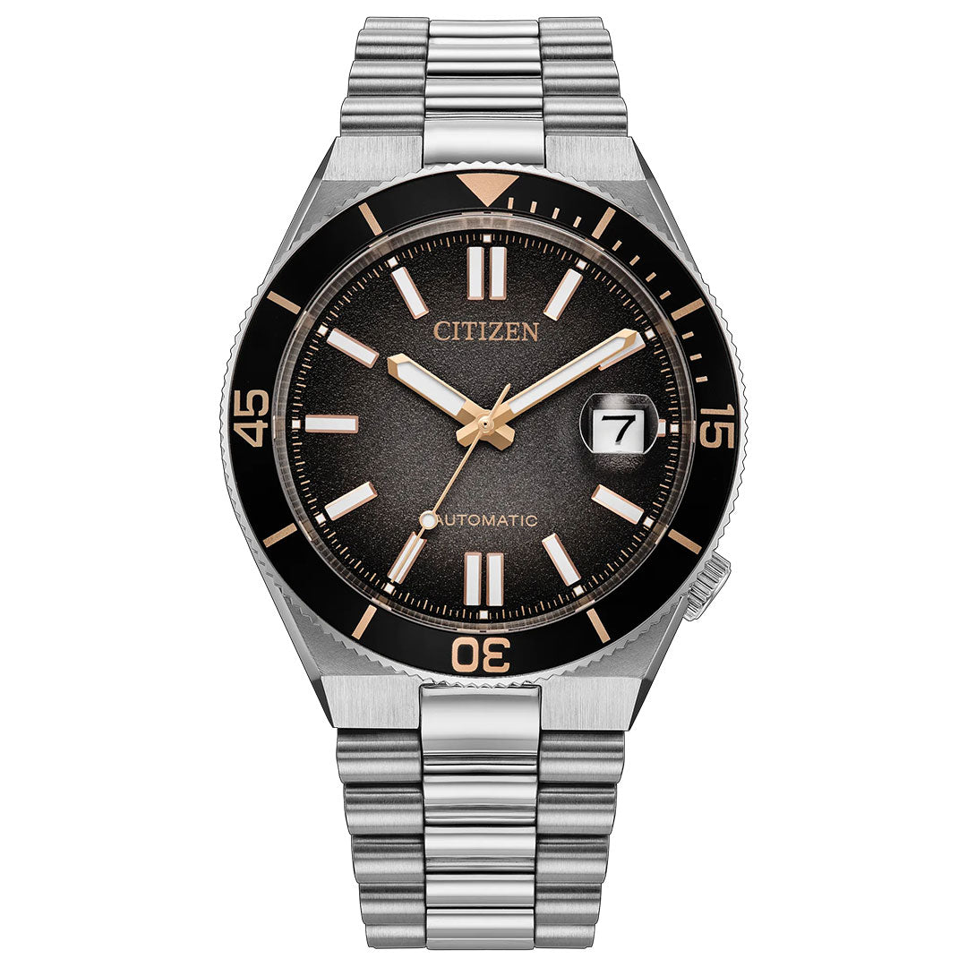 Introducing the CITIZEN TSUYOSA Shore Automatic 40mm Watch “Time Slip”—a refined modern sports watch featuring a stainless steel bracelet, black dial with gold-tone accents, prominent white hour markers, and a convenient date window at 3 o’clock. Its black bezel is marked with minute indicators at 15, 30, and 45. Powered by the automatic calibre 8210 movement from CITIZEN.