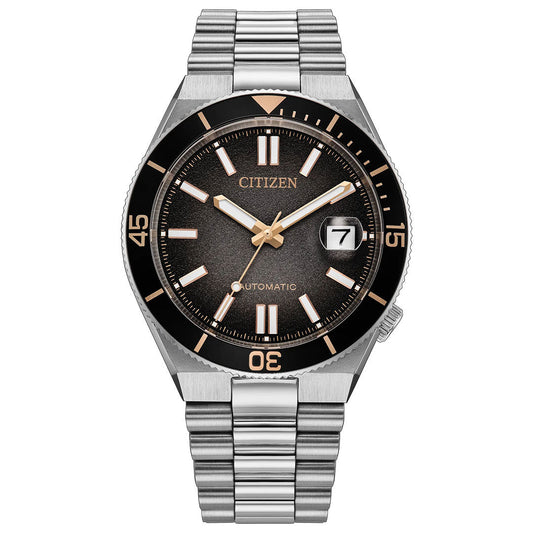 Introducing the CITIZEN TSUYOSA Shore Automatic 40mm Watch “Time Slip”—a refined modern sports watch featuring a stainless steel bracelet, black dial with gold-tone accents, prominent white hour markers, and a convenient date window at 3 o’clock. Its black bezel is marked with minute indicators at 15, 30, and 45. Powered by the automatic calibre 8210 movement from CITIZEN.