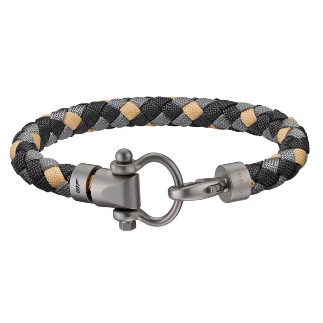 The OMEGA Aqua Sailing 007 Edition Nylon Bracelet features black, gray, and beige braids with a metallic shackle clasp—a stylish titanium design inspired by OMEGA accessories.