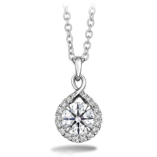 The Hearts On Fire Optima Necklace by Hearts on Fire showcases a white gold pendant adorned with a sizable round diamond at its center, encircled by smaller diamonds arranged in a teardrop shape. It is elegantly suspended on an interlinked loop chain.