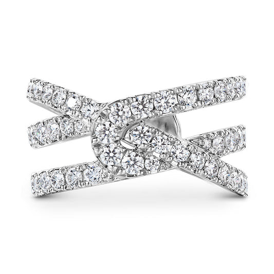 The Hearts On Fire Optima 18K white gold wrap fashion ring boasts a sophisticated crisscross design adorned with numerous small, round brilliant diamonds along the bands, offering a modern and elegant look.