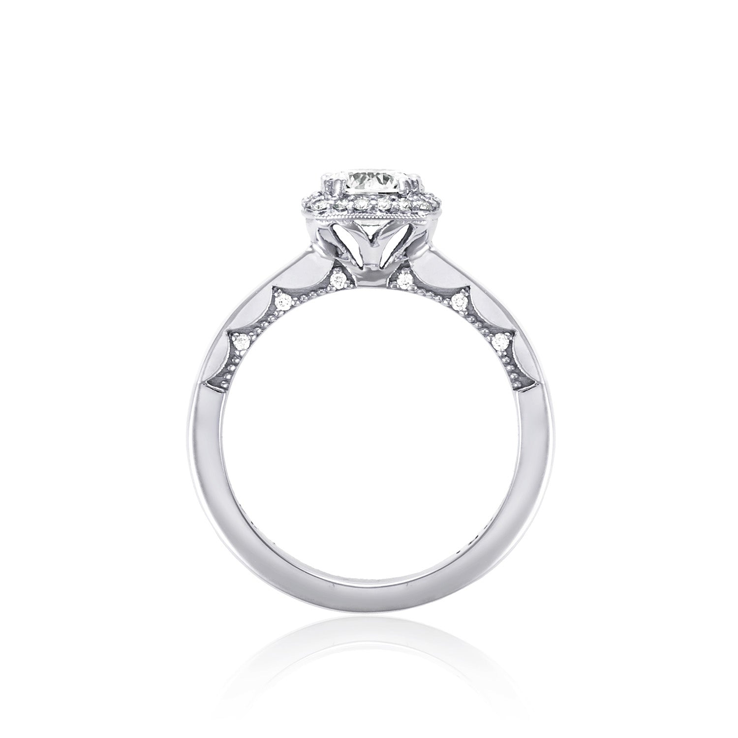 The Tacori Coastal Crescent 14K White Gold Round Brilliant Semi Mount with Diamond Band and Halo Engagement Ring features a stunning silver band with a round diamond centerpiece, intricate side detailing, and smaller diamonds embedded along the band. This elegant piece is displayed upright on a pristine white background.