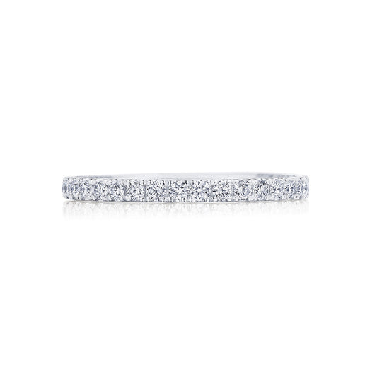 The Tacori Coastal Crescent 14K White Gold Round Brilliant French Pavé Diamond Anniversary Ring gleams magnificently against a white background, showcasing its elegant band adorned with sparkling diamonds.