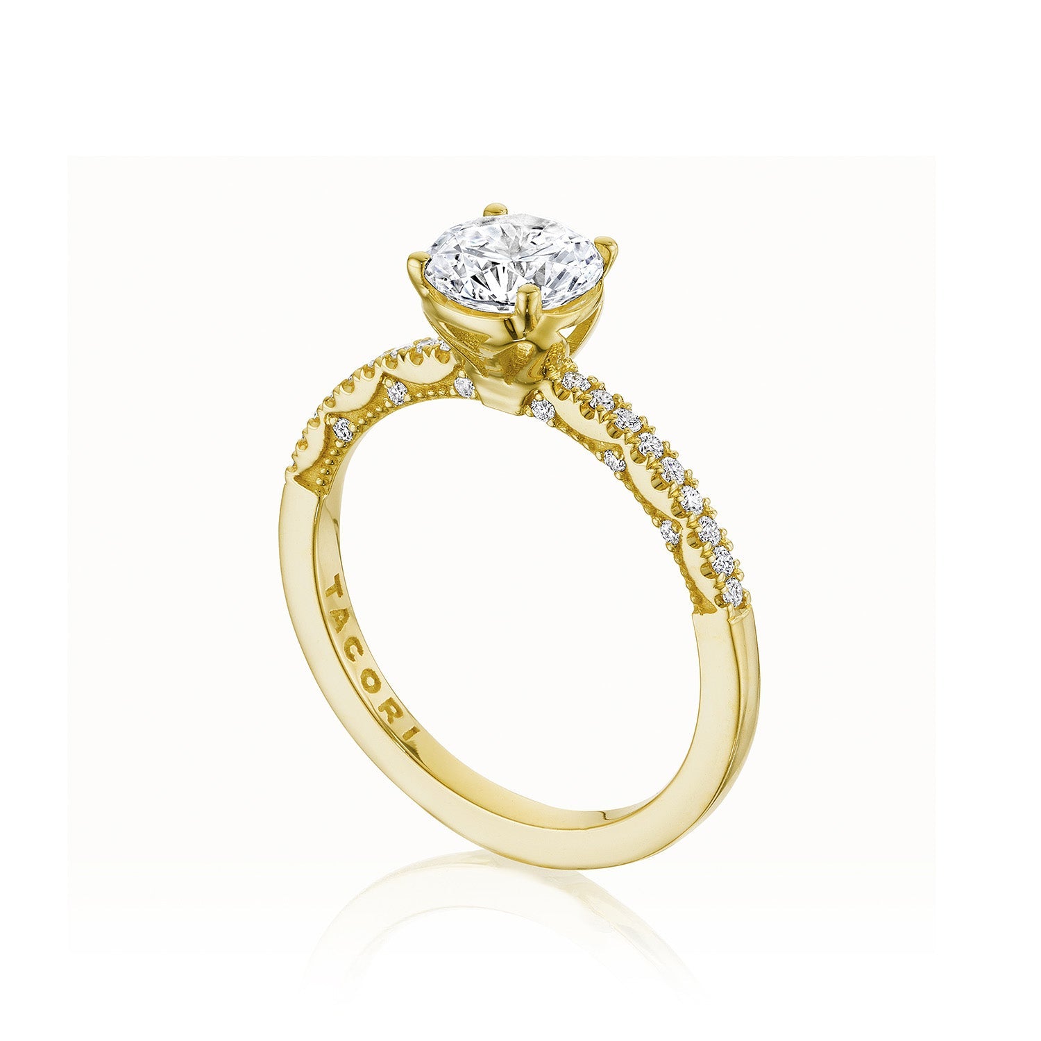 The Tacori Coastal Crescent 14K Yellow Gold Engagement Ring showcases a breathtaking round-brilliant diamond solitaire, accentuated by elegantly set small diamonds along the band.