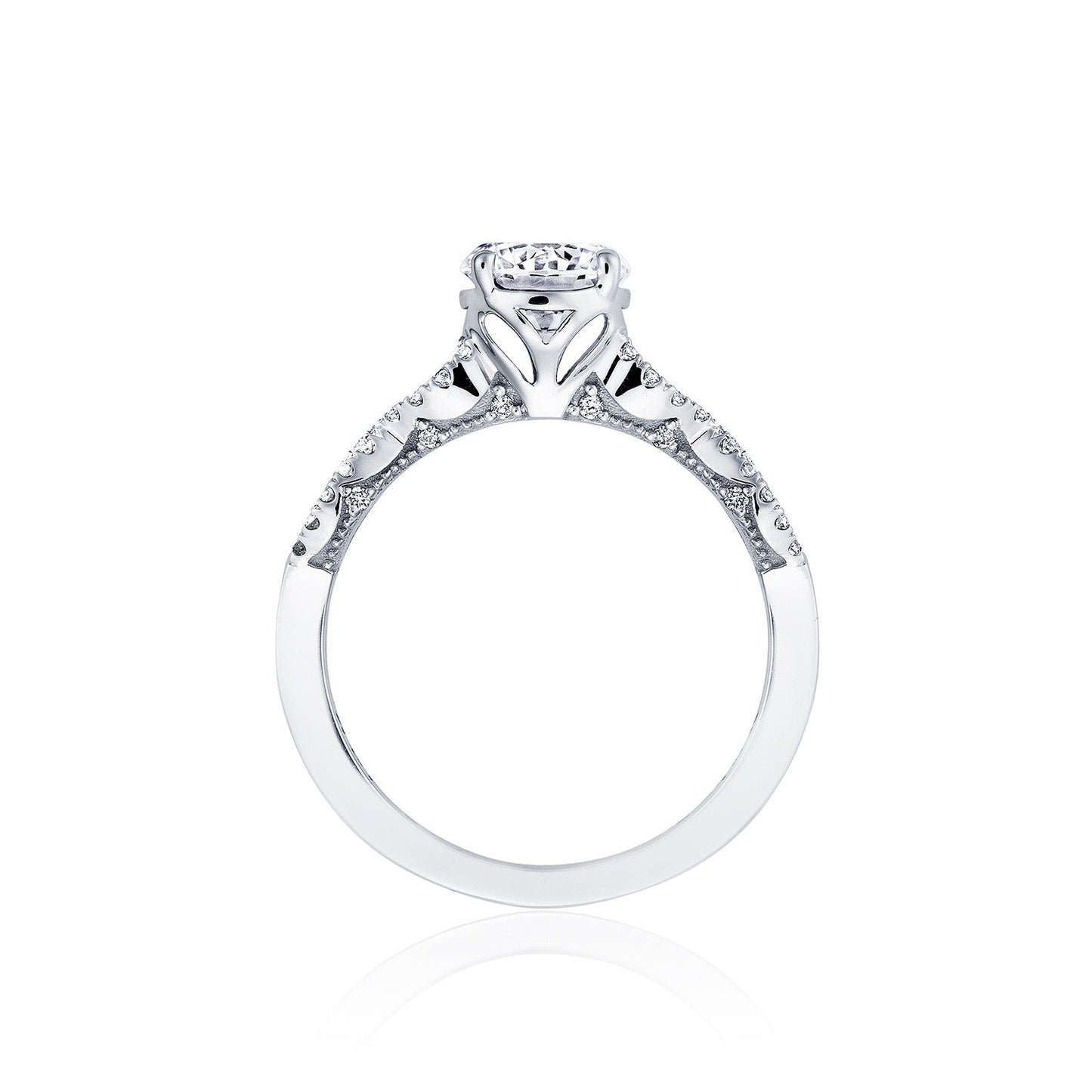 The Tacori Coastal Crescent 14K White Gold Round Brilliant Solitaire Semi Mount with Diamond Band Engagement Ring, crafted by Tacori gemologists, features an intricate Cathedral design with delicate patterns and small embedded diamonds. Displayed against a white background, the engagement ring highlights its central round diamond in a raised setting.