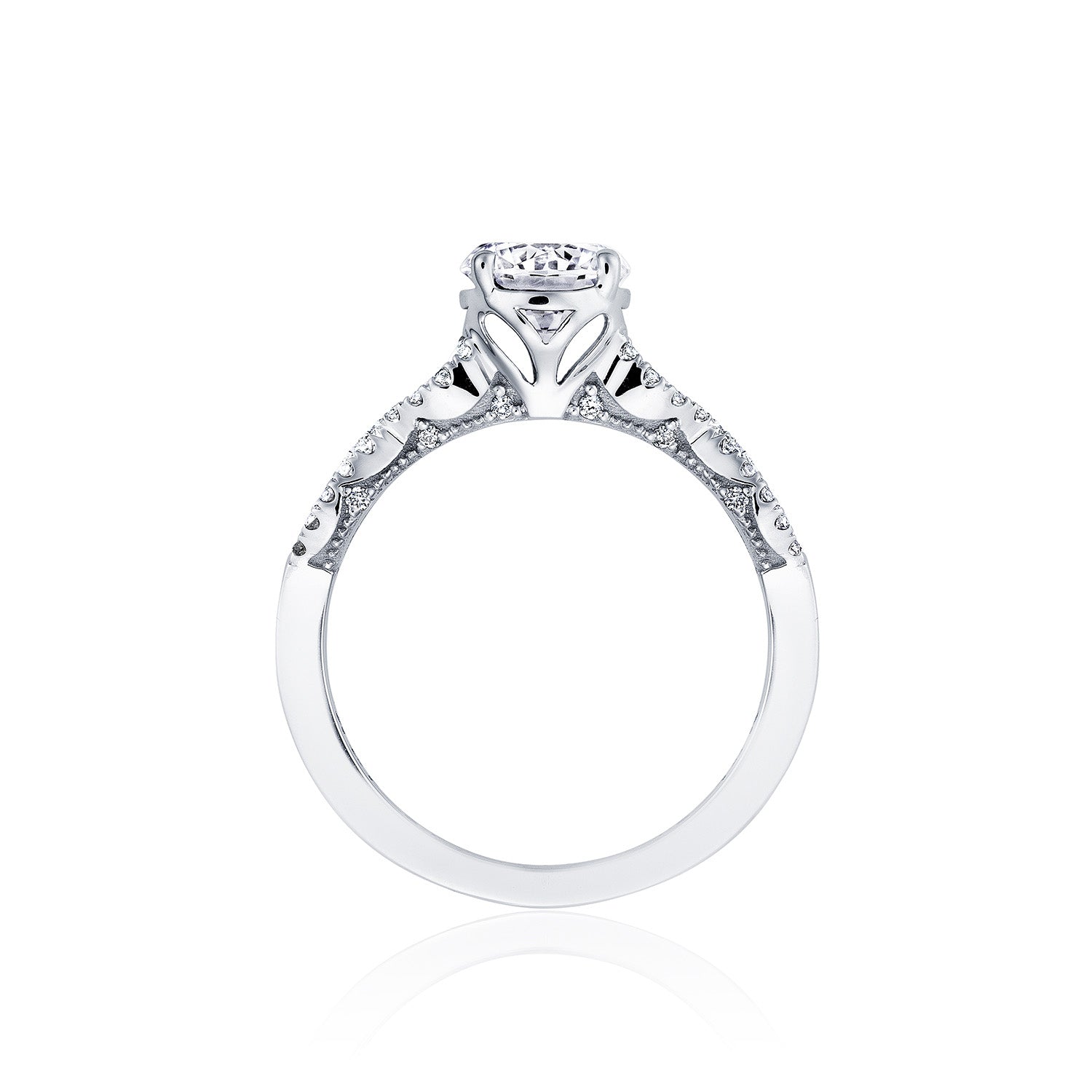 The Tacori Coastal Crescent 14K White Gold Round Brilliant Solitaire Semi Mount with Diamond Band Engagement Ring, crafted by Tacori gemologists, features an intricate Cathedral design with delicate patterns and small embedded diamonds. Displayed against a white background, the engagement ring highlights its central round diamond in a raised setting.