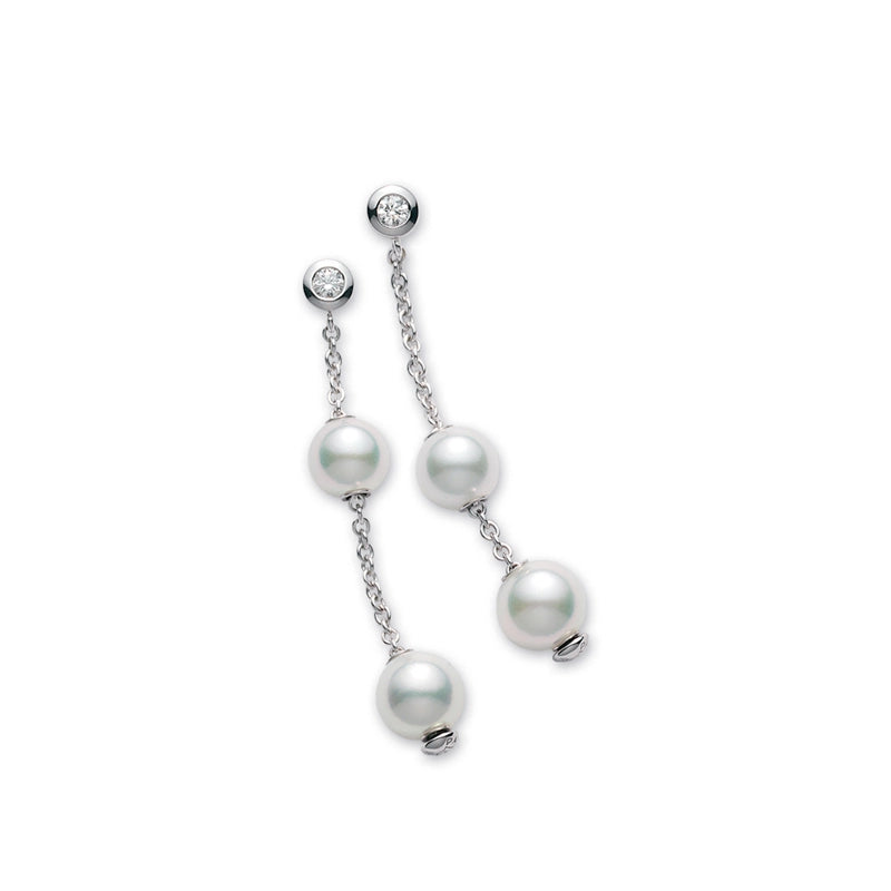 Introducing the Mikimoto Pearls In Motion 18K White Gold Akoya Cultured Pearl with Diamond Drop Earrings by Mikimoto, featuring a round diamond at the top and two radiant Akoya cultured pearls, each elegantly linked by delicate chains and beautifully displayed on a white background.