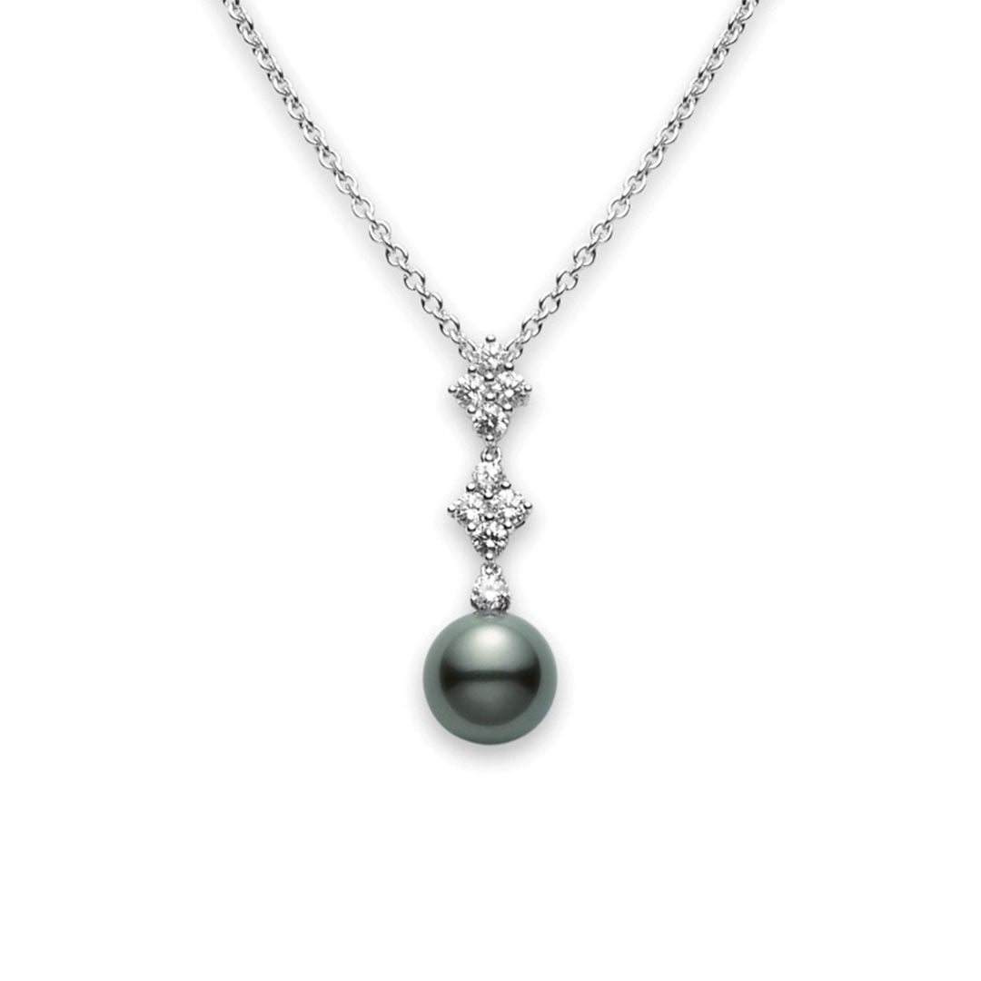 The Mikimoto Classic Elegance 18K White Gold Black South Sea Pearl with Diamond Necklace Pendant showcases a symmetrical arrangement of small diamonds above a single, large black South Sea cultured pearl. The delicate white gold chain enhances its elegance, capturing the timeless beauty that Mikimoto is renowned for.