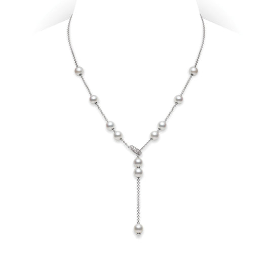 The Mikimoto Pearls In Motion Lariat Necklace features Akoya cultured pearls gracefully arranged on a slender chain, accentuated by a single pearl drop that creates an elegant Y-shape. Crafted from 18k white gold, this necklace from Mikimoto exudes a refined and understated charm.