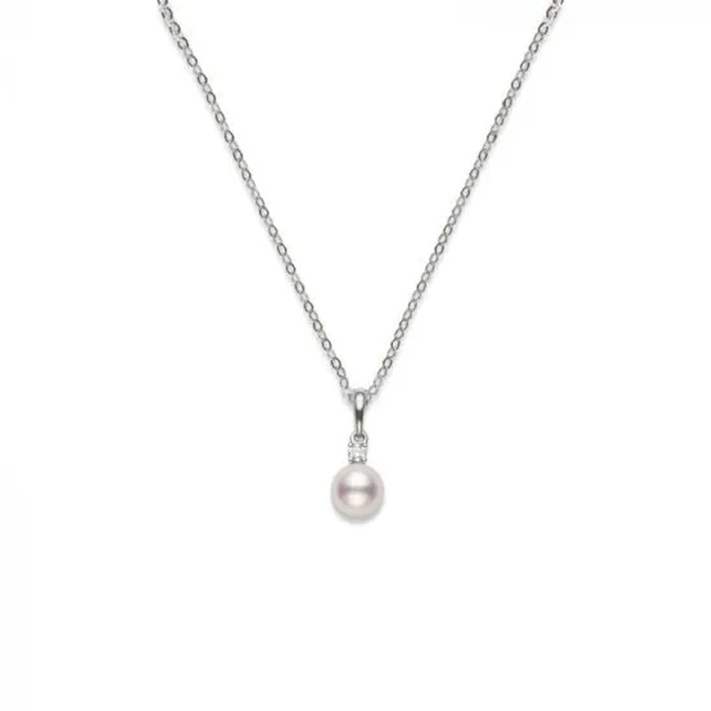 The Mikimoto 18K White Gold Diamond with Akoya Cultured Pearl Necklace Pendant showcases a refined design, featuring an Akoya cultured pearl elegantly accented by a small diamond, all set against a plain white background.