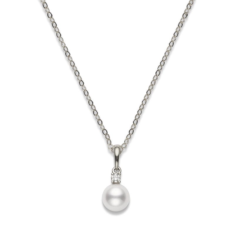 The Mikimoto 18K White Gold Akoya Cultured Pearl with Diamond Necklace Pendant features a lustrous Akoya cultured pearl, accented by a small round diamond set above the pearl on an elegant silver chain crafted from 18K white gold.