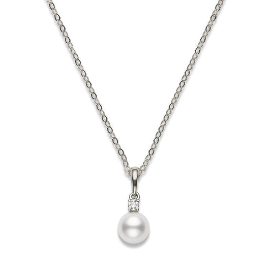 The Mikimoto 18K White Gold Akoya Cultured Pearl with Diamond Necklace Pendant features a lustrous Akoya cultured pearl, accented by a small round diamond set above the pearl on an elegant silver chain crafted from 18K white gold.