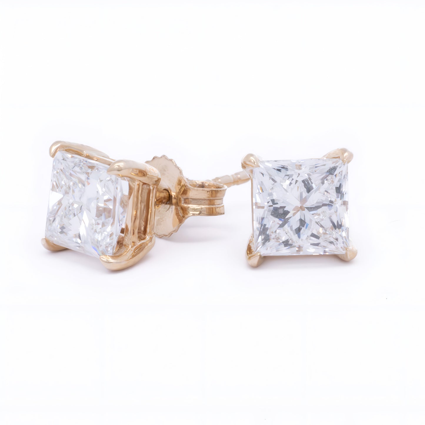 The Raffi&Co.® 14K yellow gold princess cut lab diamond stud earrings are shown on a white background, with one earring upright and the other lying on its side.
