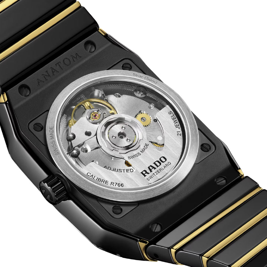 Close-up of the RADO Anatom Automatic 32.5mm Watch’s back, featuring a transparent sapphire crystal case that reveals its CALIBRE R766 mechanical movement, labeled "SWISS MADE," with a high-tech ceramic bracelet by RADO.