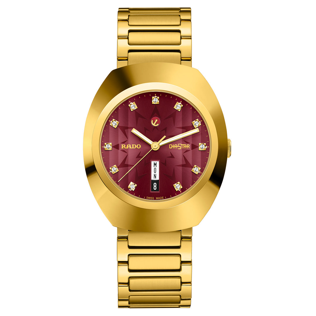 The RADO DiaStar Original Automatic 38mm Watch features a gold case, red dial with diamond hour markers, gold hands, sapphire crystal, day-date display at 6 o’clock, and “RADO” and “DIASTAR” on the dial.