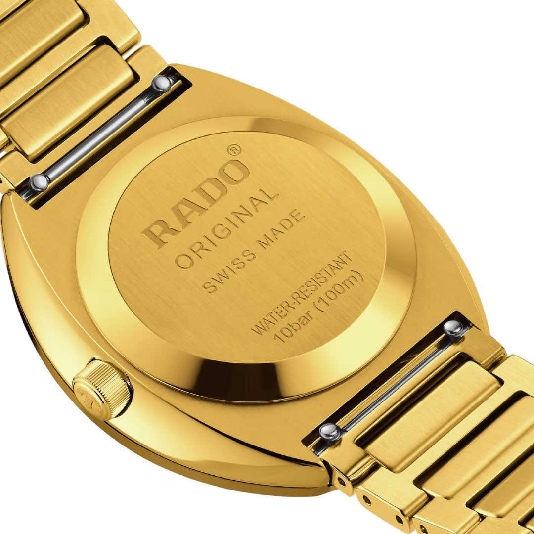 Close-up of the back of a RADO DiaStar Original Automatic 38mm Watch in yellow gold, showing engraved "RADO Original Swiss Made Water-Resistant 10 bar (100 m)" along with visible bracelet links and crown.