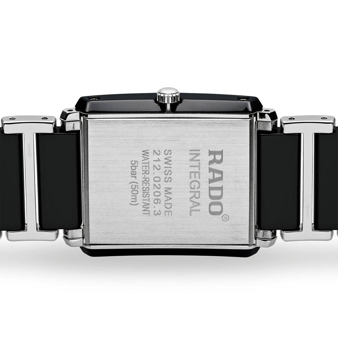Close-up of the back of a RADO Intergal Diamonds Quartz 31mm watch, highlighting its rectangular silver case with model details and "Swiss Made" engraving, plus a black and silver high-tech ceramic link bracelet.