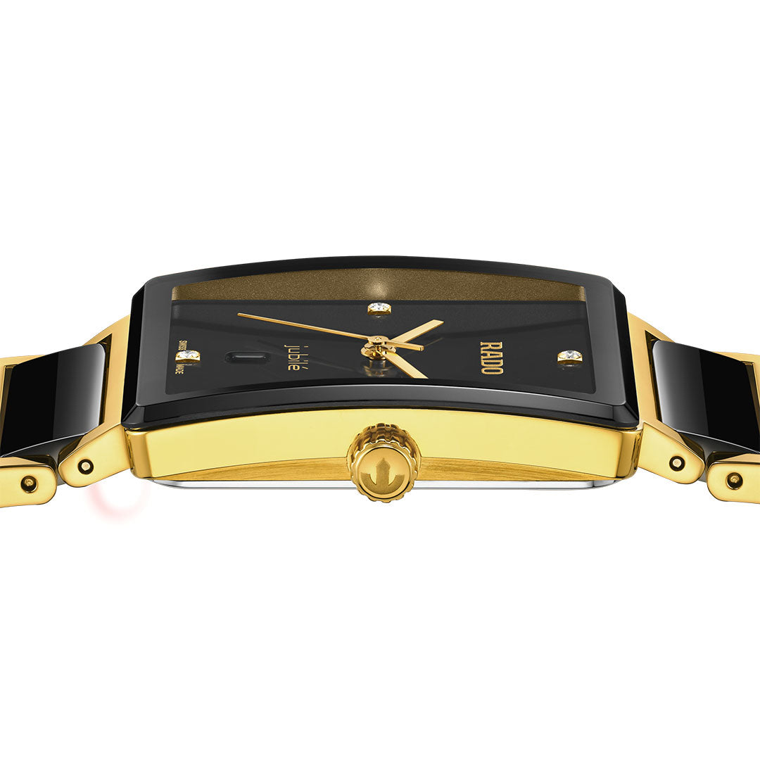 A close-up side view of the RADO Integral Diamonds Quartz 31.5mm watch featuring a rectangular black dial, gold-tone hands, sapphire crystal, gold crown, and a black and gold bracelet by RADO.