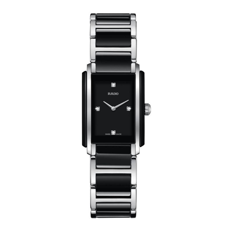 The RADO Integral Diamonds Quartz 22.7mm x 33.1mm Watch is a stylish timepiece featuring a rectangular black dial with silver accents, incorporating advanced ceramic technology. It includes silver hour and minute hands, a stainless steel and black ceramic link bracelet, and small diamond markers at the 3, 6, 9, and 12 positions.