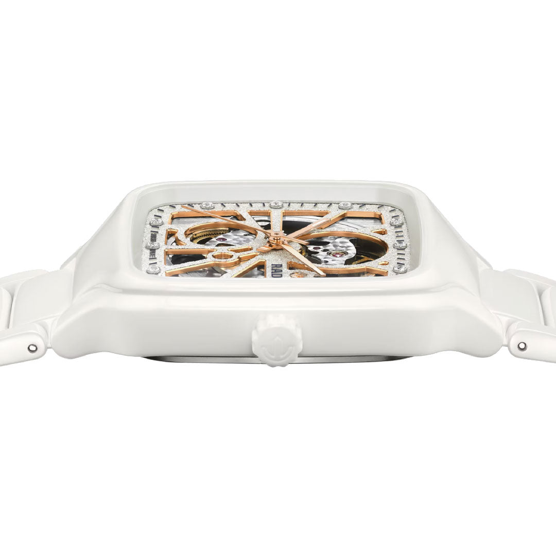A close-up side view of the RADO True Square Automatic Open Heart Sparkling 38mm Watch featuring a white case and band, an exposed automatic movement on the skeleton dial, and a detailed crown.