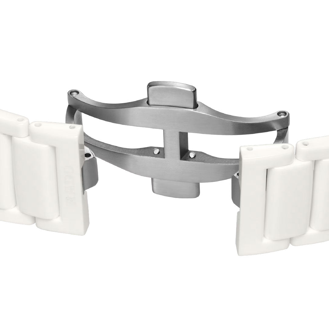 A close-up shows the metal butterfly deployment clasp, partially open, on the band of a RADO True Square Automatic Open Heart Sparkling 38mm Watch, set against a white background.