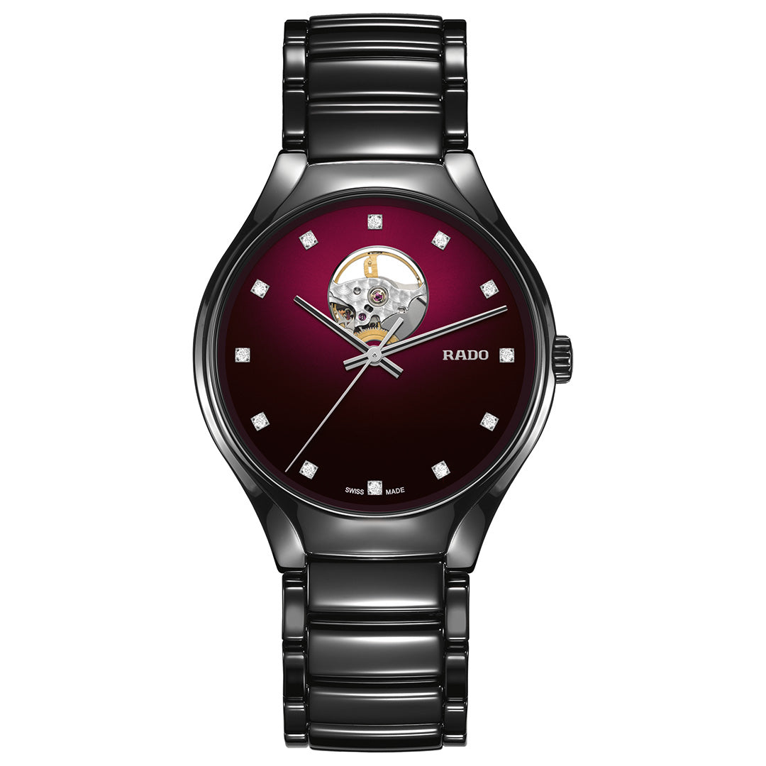 The RADO True Round Secret Automatic 40mm Watch features a black high-tech ceramic band, burgundy gradient dial, diamond hour markers, and an exposed mechanical movement at 12 o’clock.