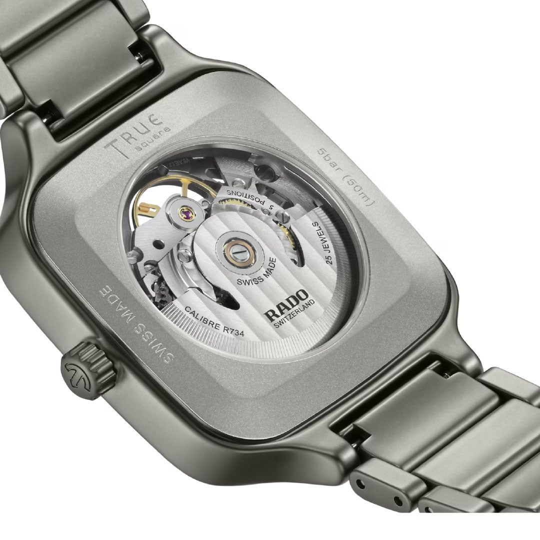 Close-up of the RADO True Square Automatic Skeleton 38mm reveals its transparent case back, highlighting the Swiss skeleton movement and engraved details such as "Swiss Made" and "Calibre R734".