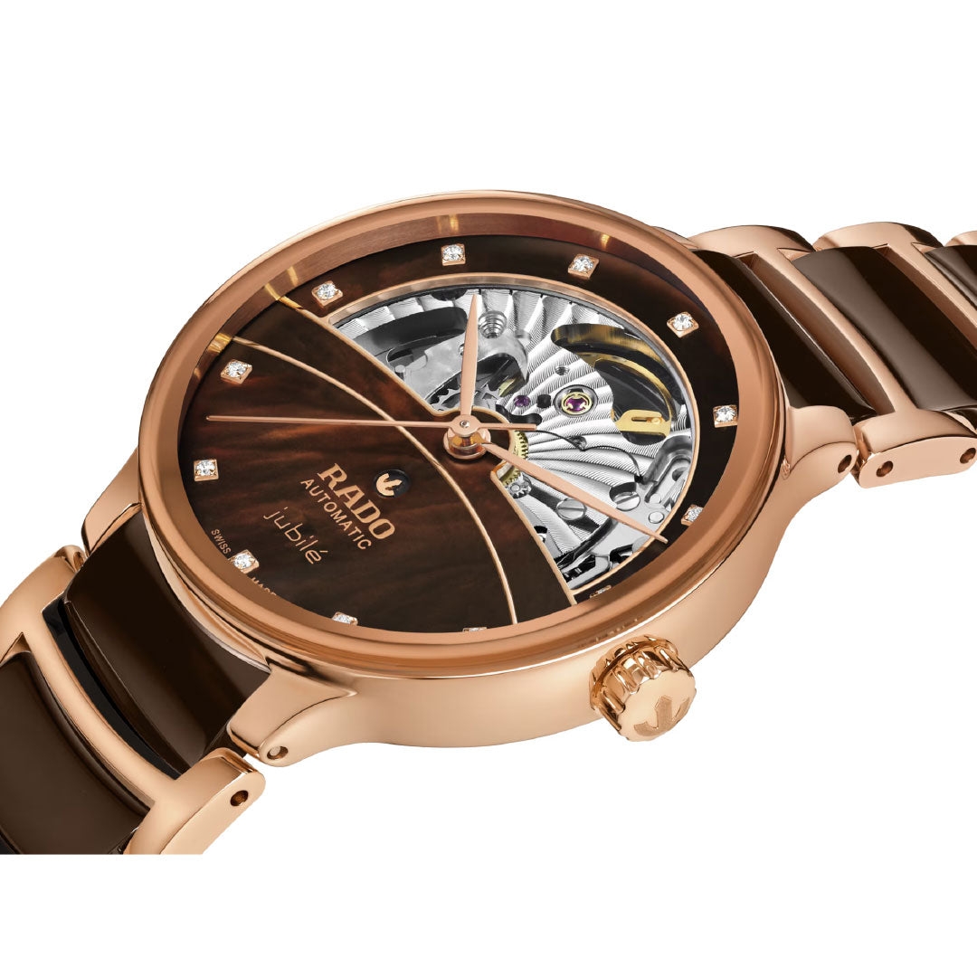 A close-up of the RADO Centrix Automatic Diamonds Open Heart 35mm Watch showcases its partially open-worked dial, automatic movement, and sparkling diamond hour markers.