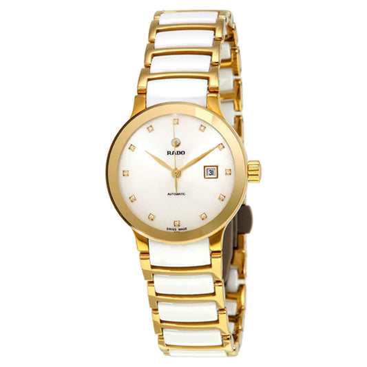 The RADO Centrix Automatic 28mm Watch boasts an elegant gold and white design, featuring a round dial and a metallic strap. It is adorned with sapphire crystal, small square hour markers, and a date window at the 3 o'clock position. Additionally, it includes an automatic movement indication with the brand name prominently displayed on the dial.