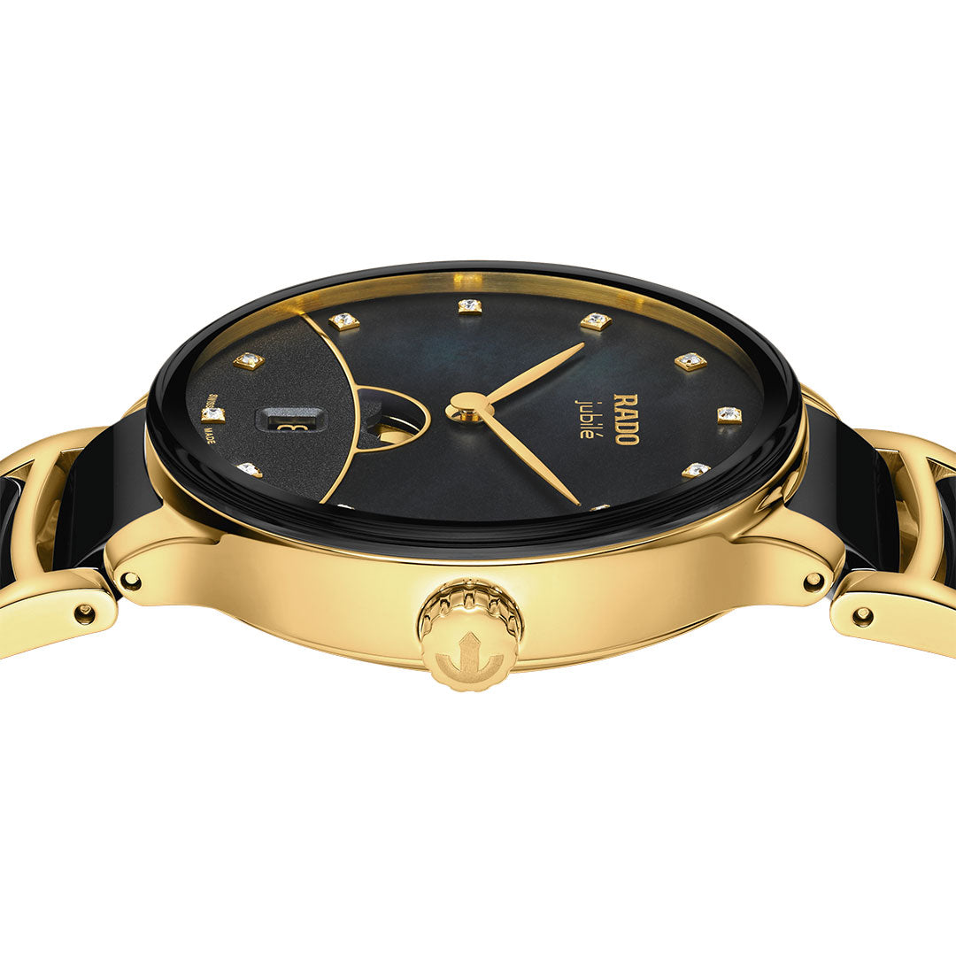 A close-up side view of the RADO Centrix Moonphase Quartz 35mm watch, featuring a black face with diamond hour markers and a gold crown bearing the RADO logo.